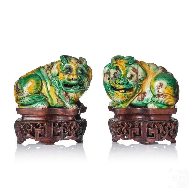 A pair of egg and spinach glazed figures of mythical creatures,